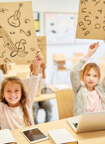 shutterstock__girls-elementary-school-hold-signs-creativity-1658491072_Robert_Kneschke.jpg